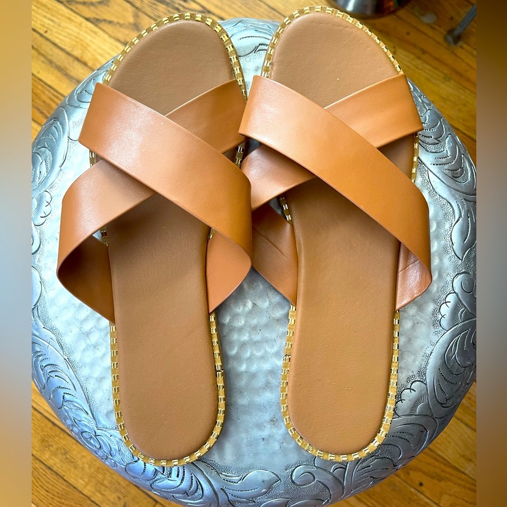 Brand new Cute brown vegan cross slides with gold trim.